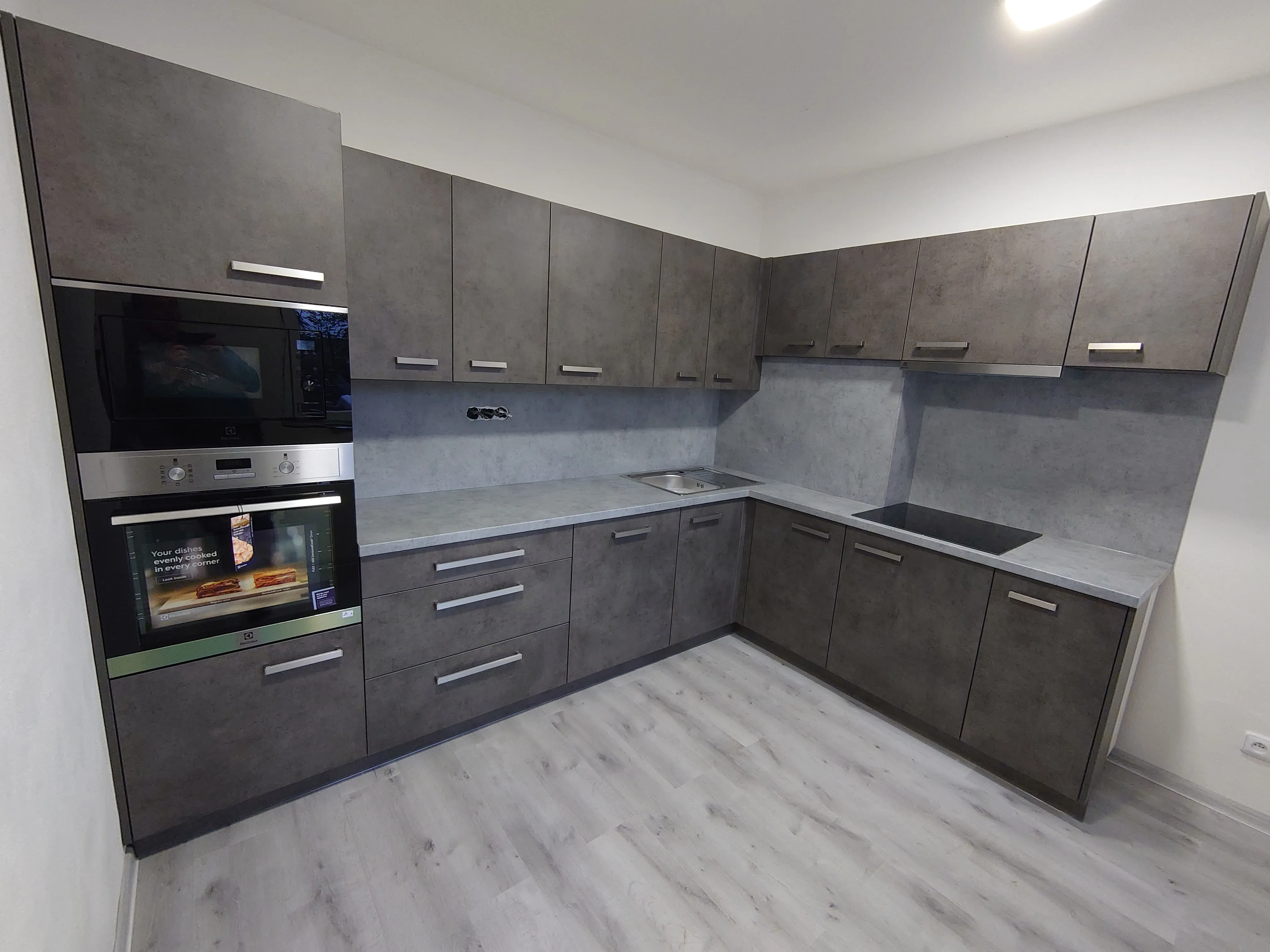 Moderní šedá kuchyně na míru — dekor beton, L-tvar, zakázková výroba